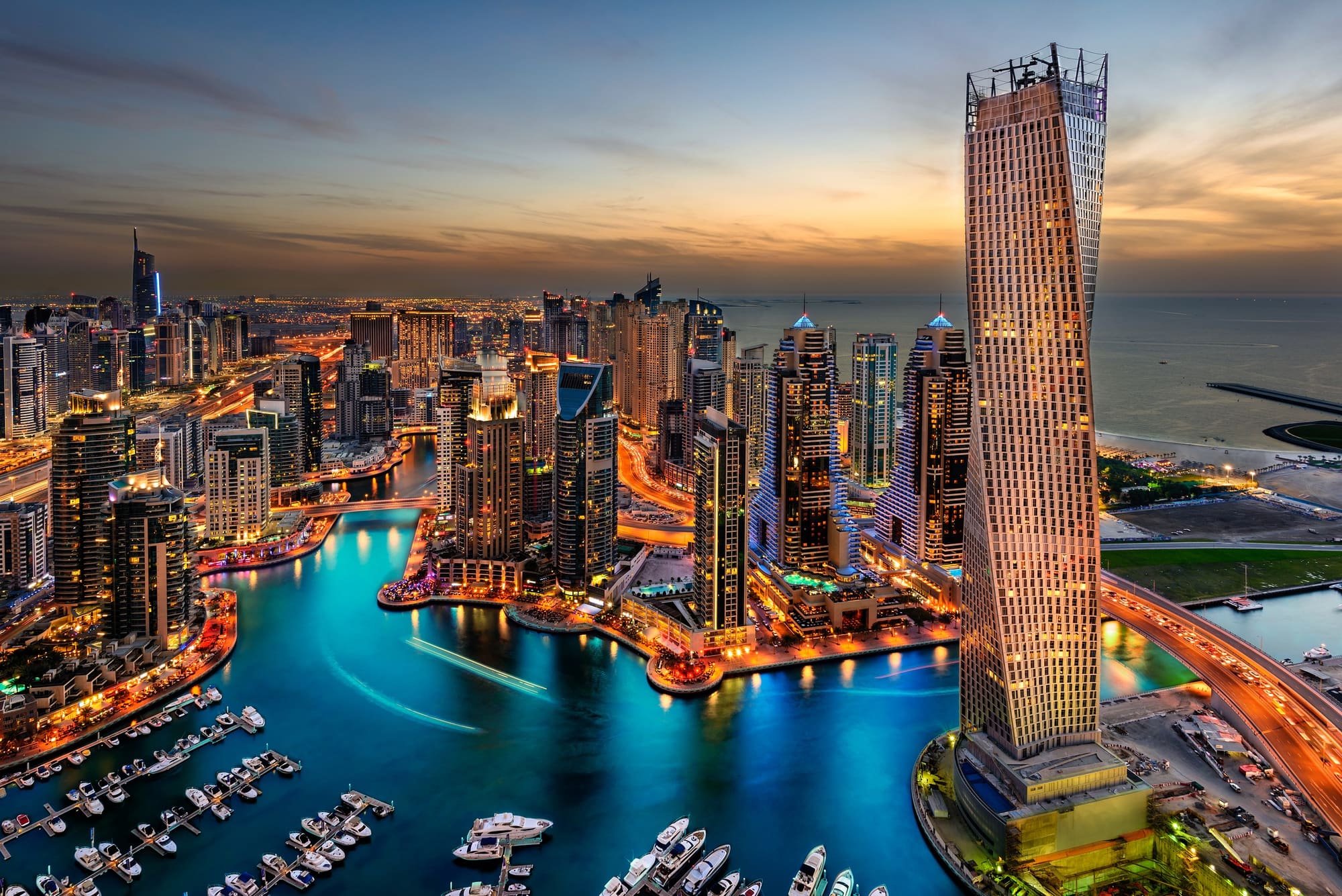 Dubai Marina towers rising above the water at golden hour