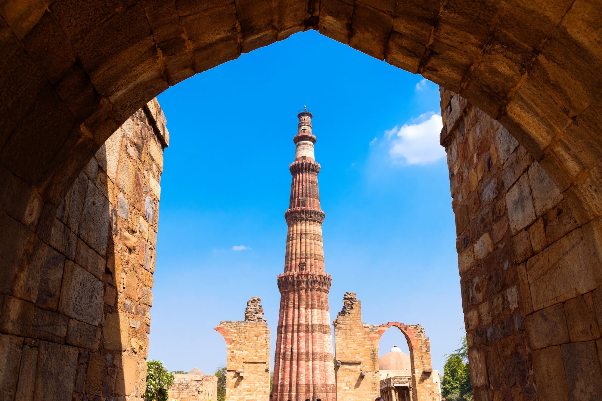 The Qutub Minar rising above the ruins of the Qutb complex in Delhi